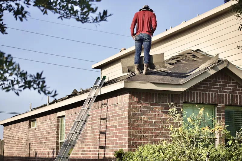 Professional roofer working on a residential roof in Macon-Bibb County